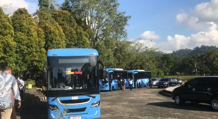 Warga Unand beserta tamu undangan menaiki Bus Trans Padang di depan Auditorium Universitas Andalas, Senin (19/12/2022). (Genta Andalas/Nabila Annisa)